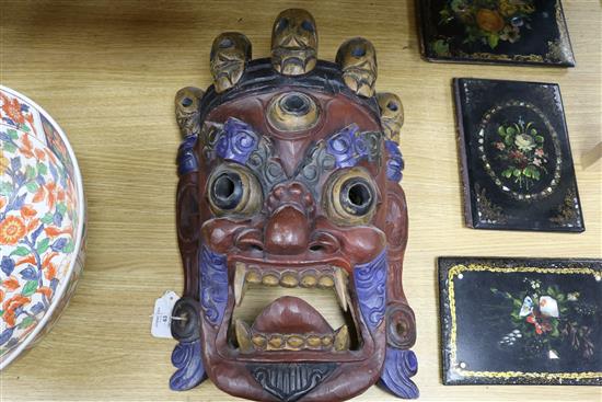 A Tibetan carved wood mask length 44cm approx.